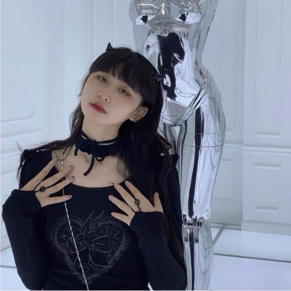 Black long sleeve top with ruffles and bows
